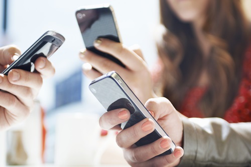 hands texting with mobile phones in cafe