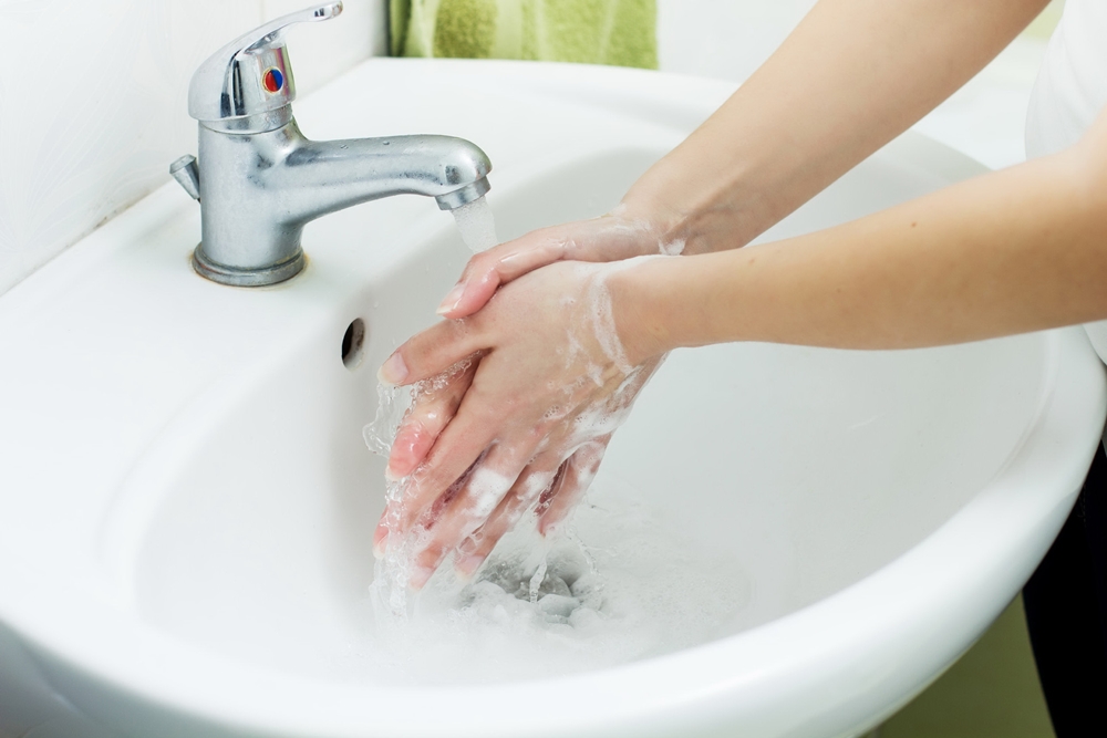 38628779 - washing hands with streaming water in bathroom. hygiene